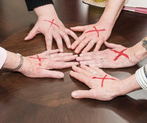 CSJP Leadership Team with red x's marked on their hands to show support for the End Slavery Intiative